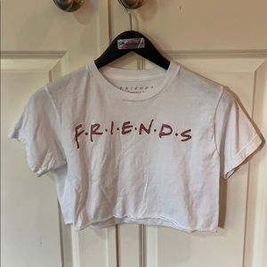 White crop tee with “friends” logo on front.
